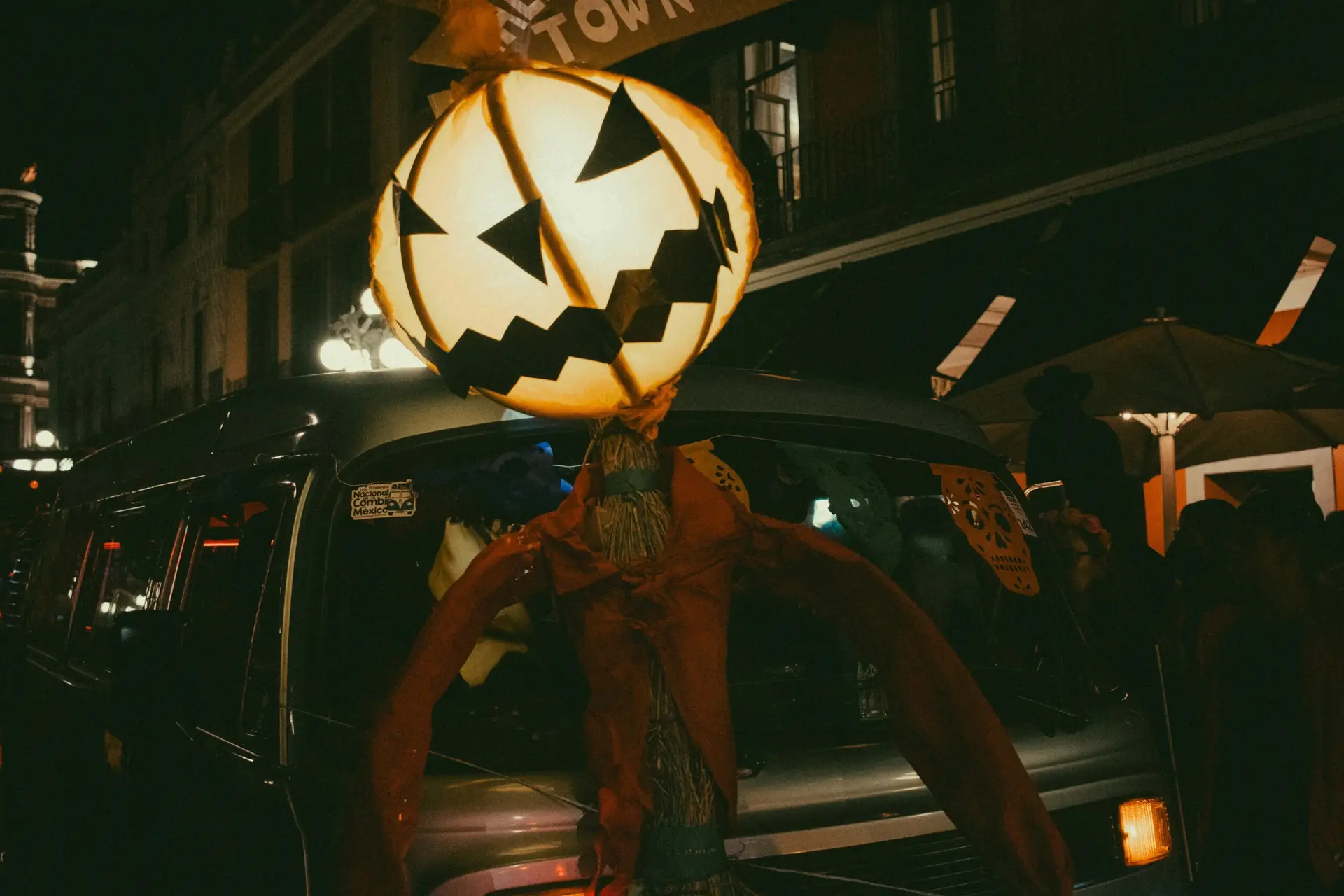 a person with a jack o lantern on their head